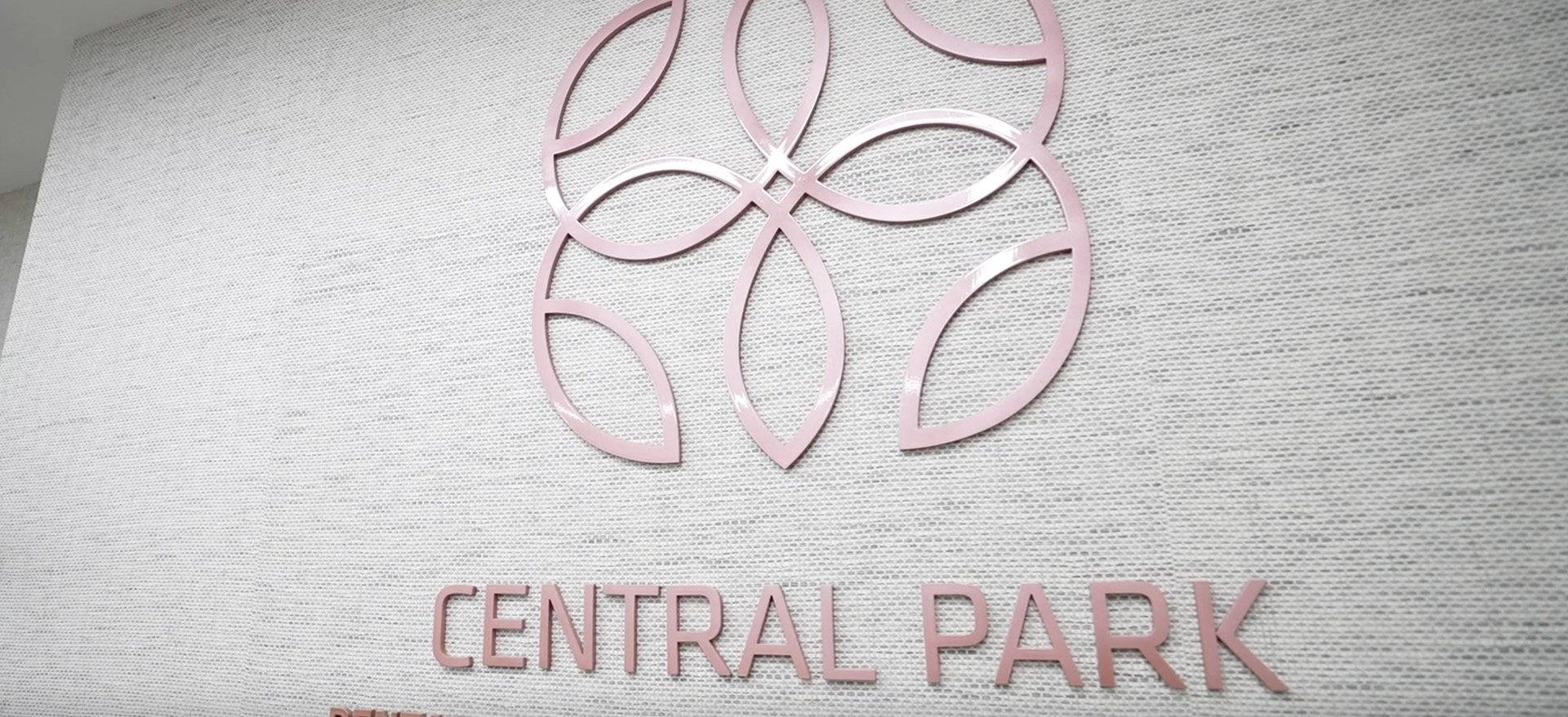 The image features a sign with the text CENTRAL PARK on a background with a circular pattern.
