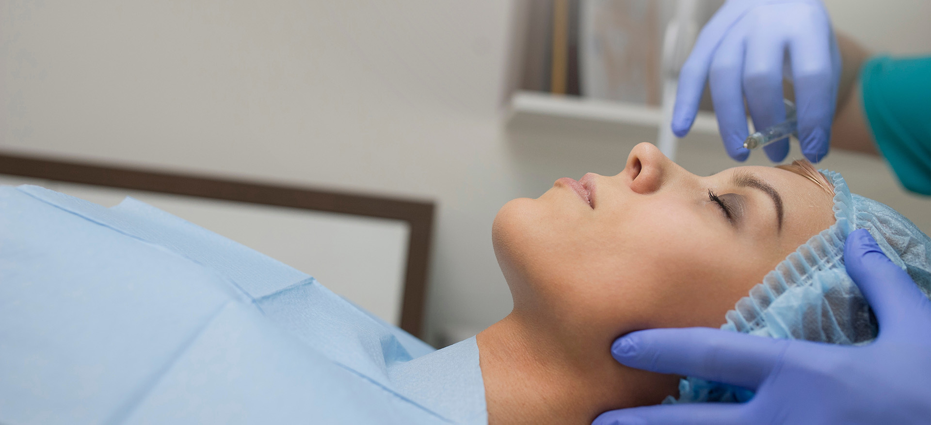A person receiving medical treatment with a nurse attending to them.