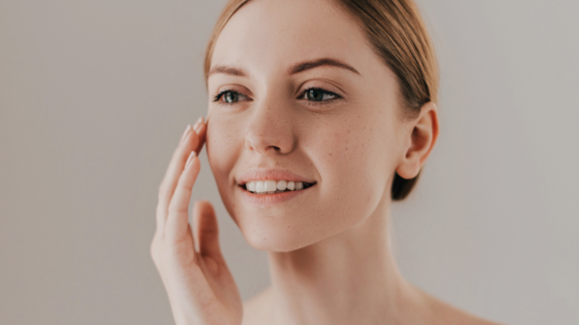 The image shows a woman with her eyes closed, receiving a facial treatment, possibly at a spa or beauty salon.