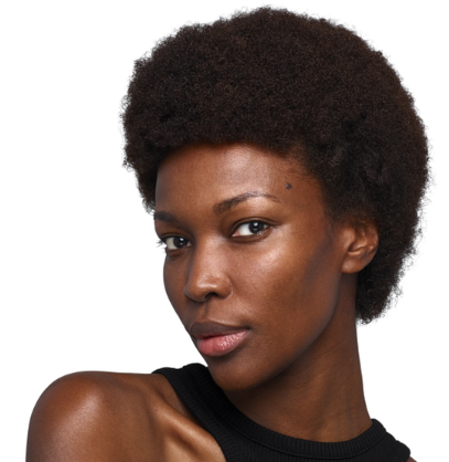 A person with short curly hair and a full beard, wearing a black top, against a white background.
