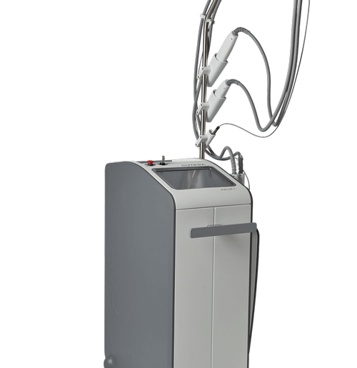 The image shows a modern dental chair with a movable overhead light, which appears to be a professional dental equipment setup.