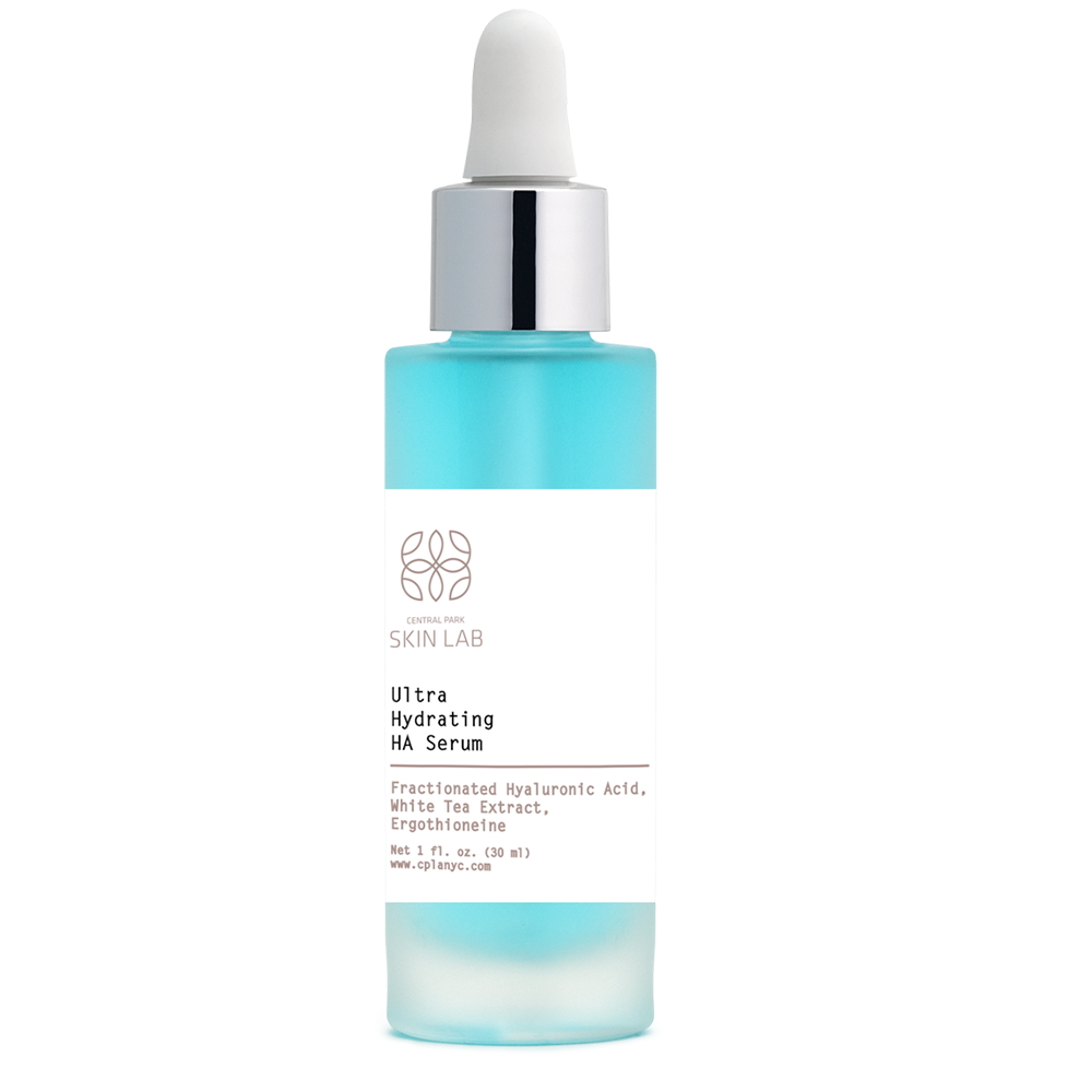 The image shows a bottle of serum with a white label featuring text and a blue background, placed against a neutral backdrop.